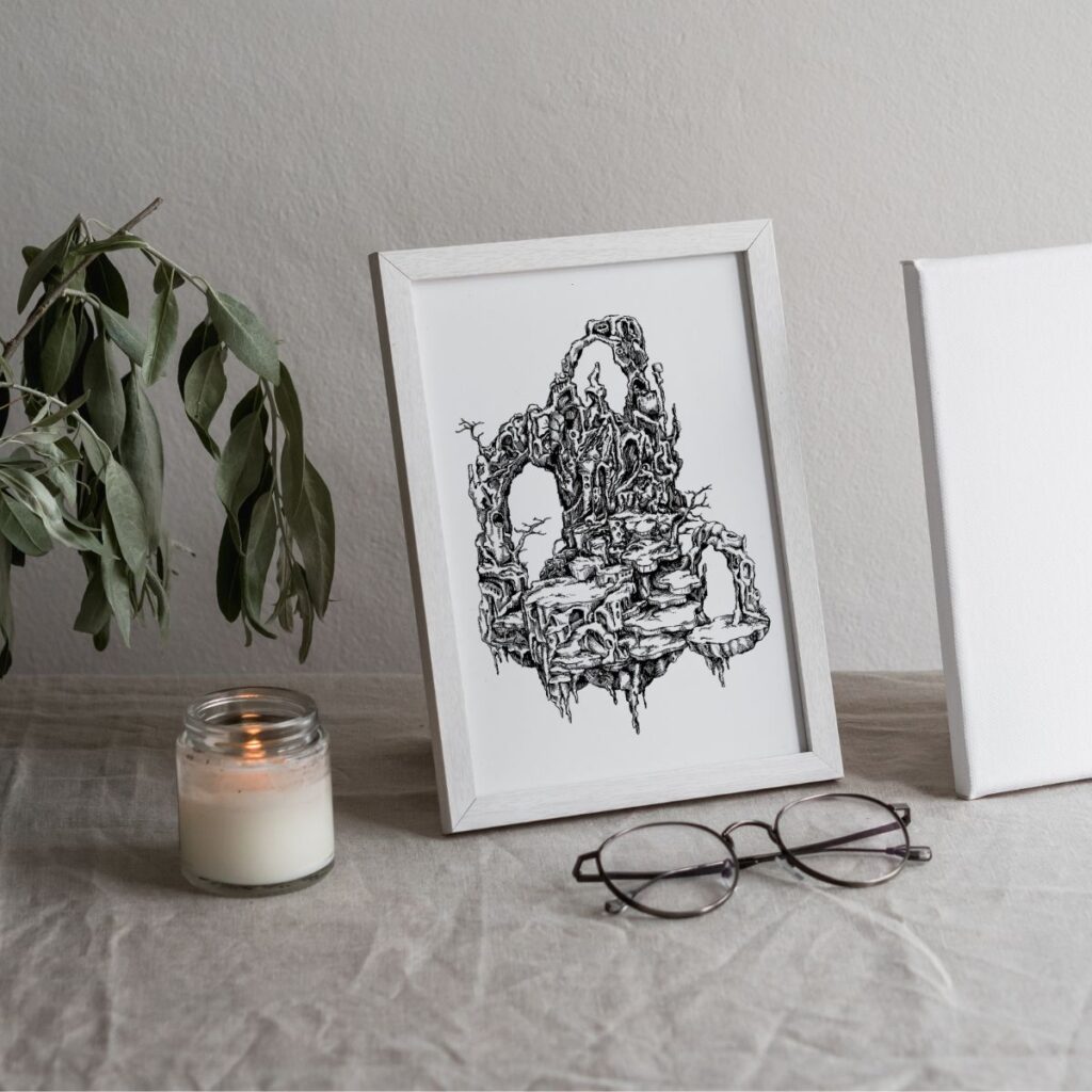 Small-sized "Cliffs" poster in a white frame, placed on a fabric-covered table next to a candle and reading glasses, perfect for minimalist decor.