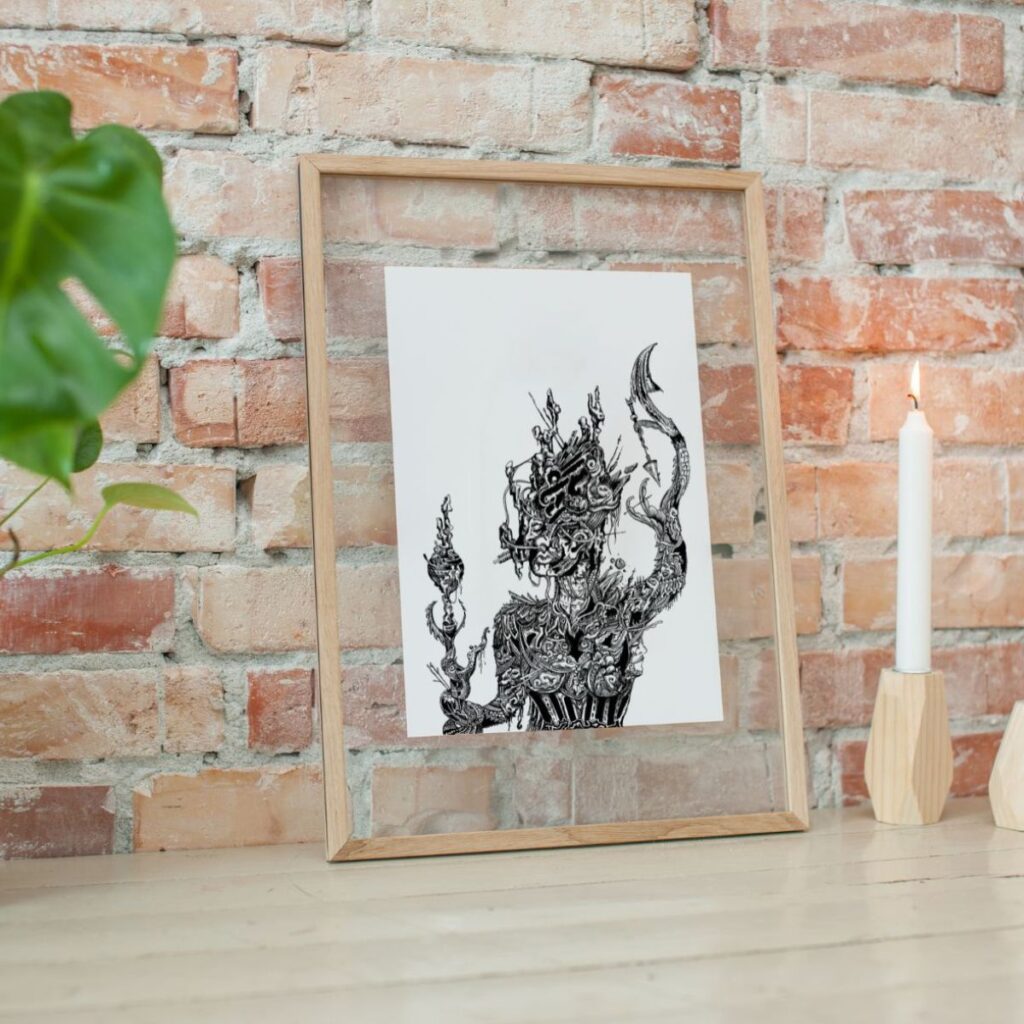 "goddess" drawing in a wooden frame leaning against a brick wall, styled with a candle and greenery, adding an artistic and serene vibe to the decor.