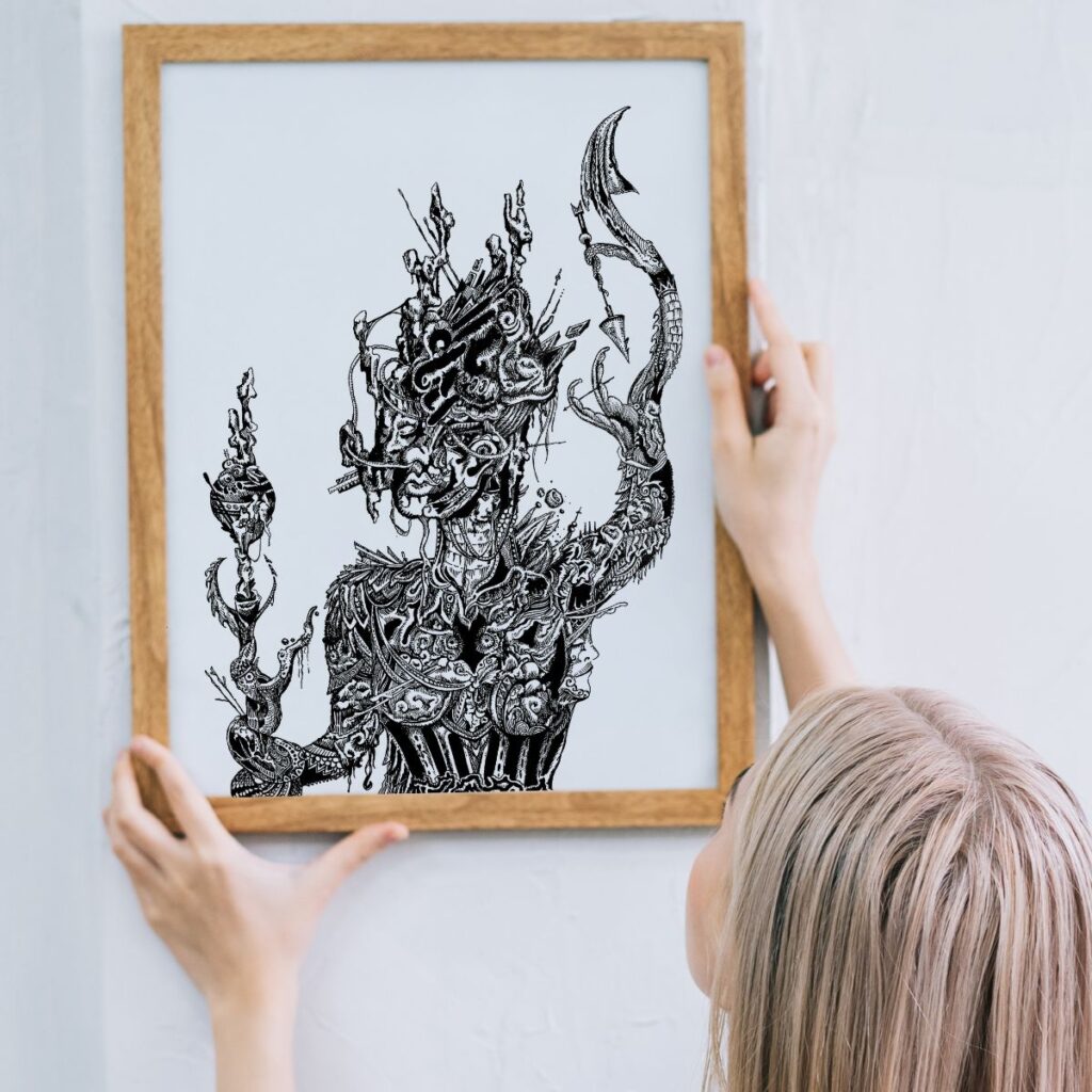 erson holding the "goddess" poster in a wooden frame against a light wall, showcasing an intricate, detailed design inspired by mythical elements perfect for modern home decor.