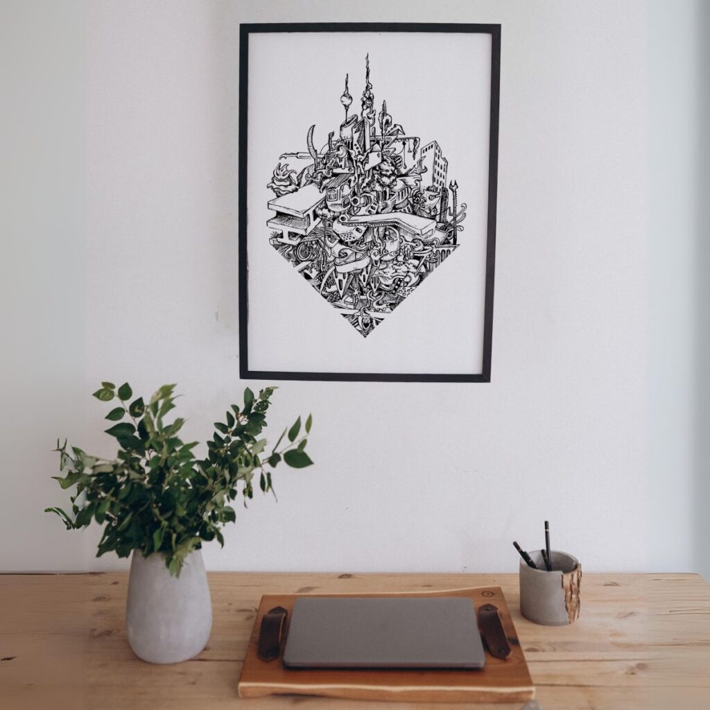 Framed "i-beam" poster displayed above a wooden desk with a plant, enhancing a minimalist home office setup with its bold, industrial design.