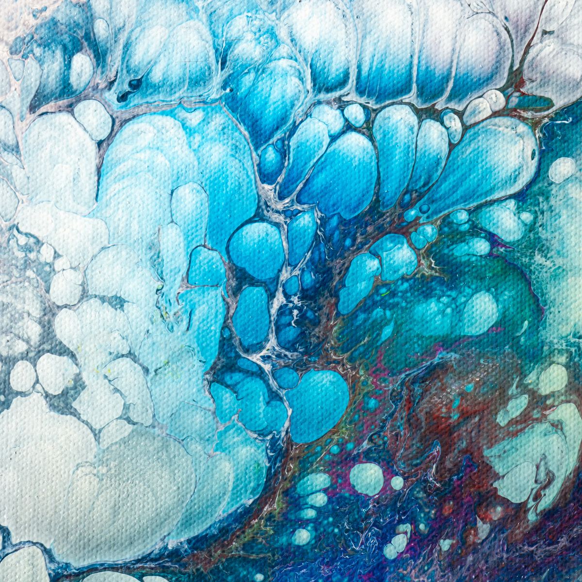 Mesmerizing acrylic pour painting with swirling blue and white patterns